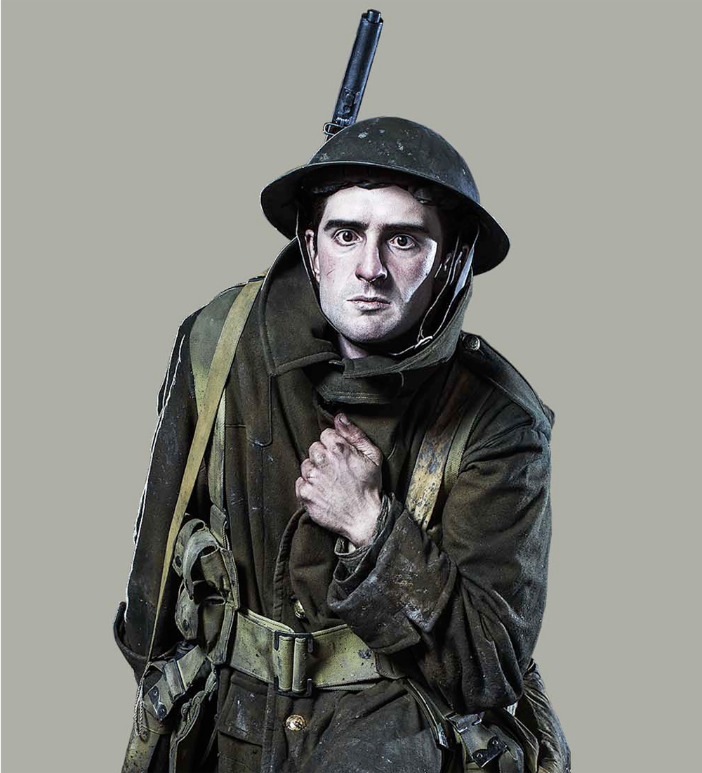 Thumbnail image. A World War I soldier illustration in a worn olive-green uniform crouches, gripping his coat. His pale, determined face is framed by a steel helmet with a bayonet affixed.