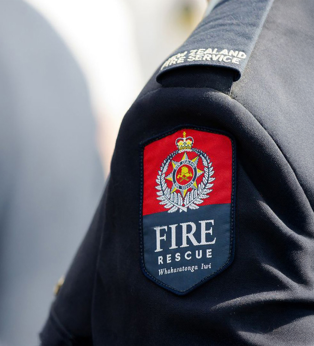 Thumbnail image. The image shows a New Zealand Fire Service uniform with a "FIRE RESCUE" badge and emblem.